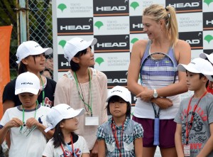 Maria Sharapova of Russia (R) speaks with girls from Fukushima prefecture during the charity tennis clinic with children from the March 11 earthquake and tsunami disaster hit area, one day before the Pan Pacific Open tennis in Tokyo on September 22, 2012. The Pan Pacific Open tennis starts on September 23. AFP PHOTO / TOSHIFUMI KITAMURA (Photo credit should read TOSHIFUMI KITAMURA/AFP/GettyImages)